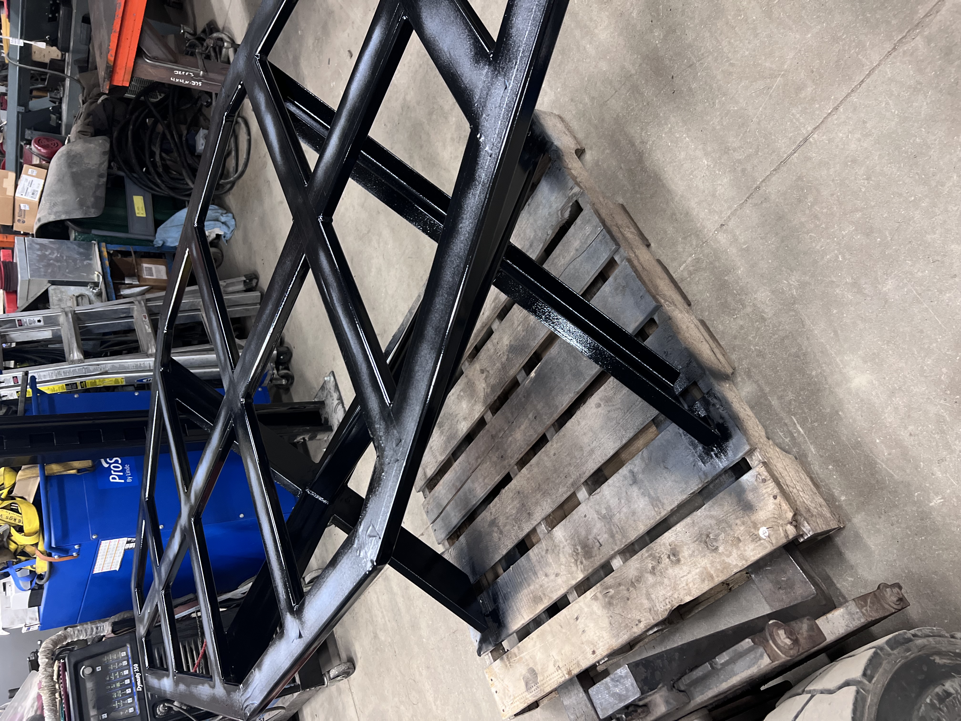 Newly fabricated black steel frame, possibly for equipment stand or trailer component. Clean fabrication example.